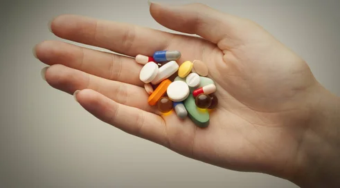 Pills on a person's palm