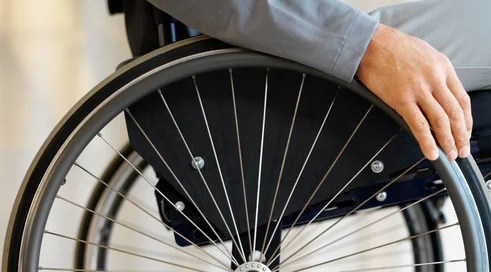 close up mid section view of a man sitting in a wheelchair